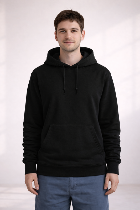 Front view of a man wearing a plain black pullover hoodie with drawstrings and kangaroo pocket.