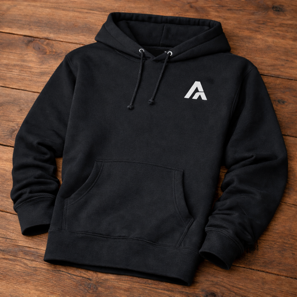 Black hoodie with a white logo on a wooden surface
