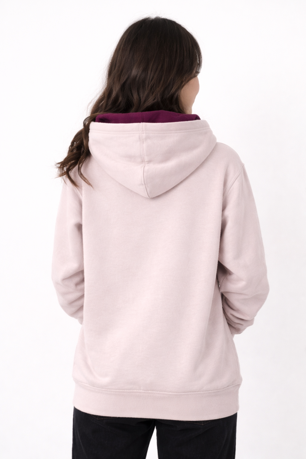 Person wearing a light pink hoodie with a dark collar on a white background