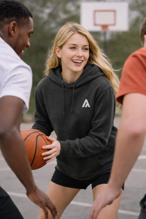 Woman holding a basketball on a basketball court with two other people.