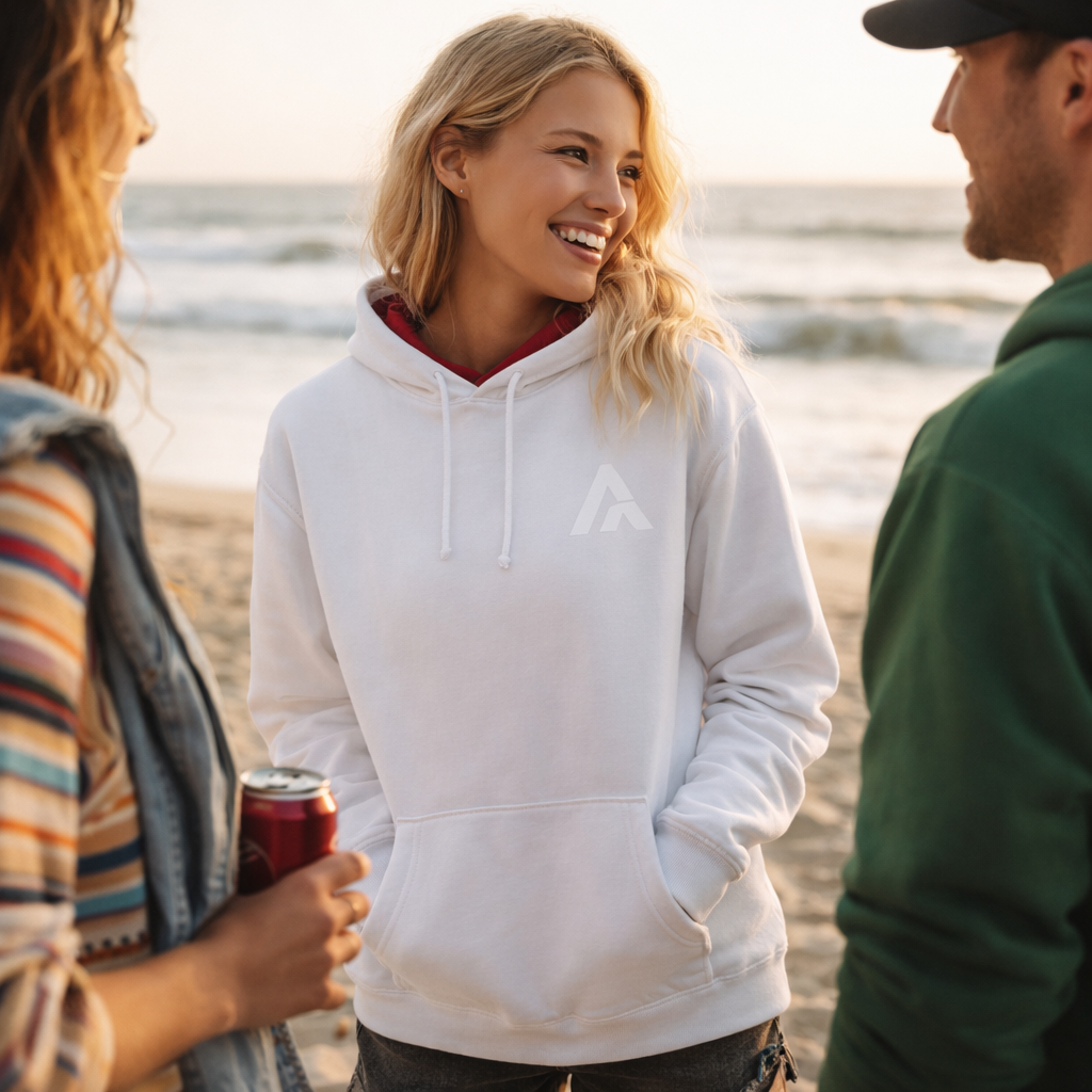 People standing on a beach, enjoying each other's company with a scenic background.