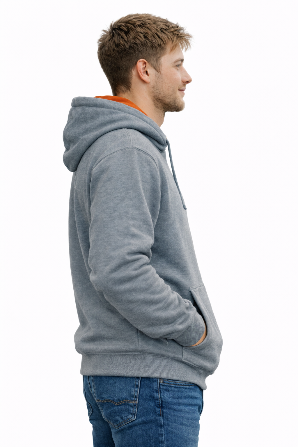 Man wearing a gray hoodie and blue jeans on a white background