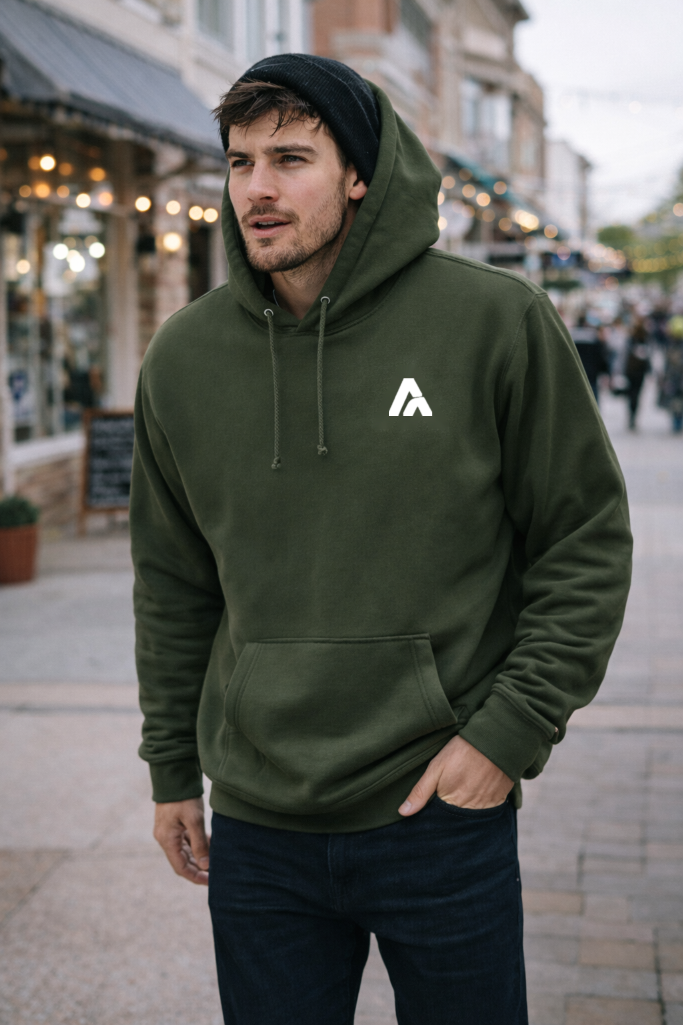 Man wearing a green hoodie with a logo on a city street