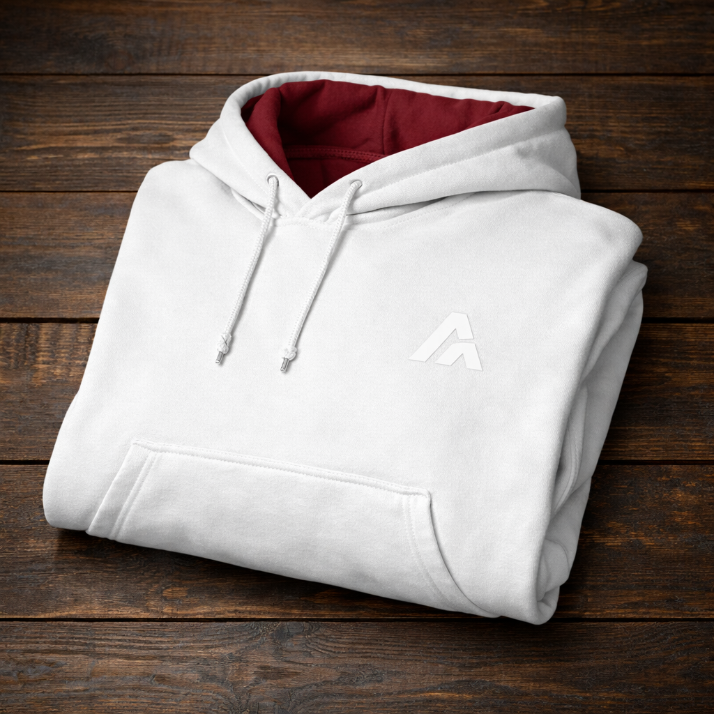 Folded white hoodie with a logo on a wooden surface