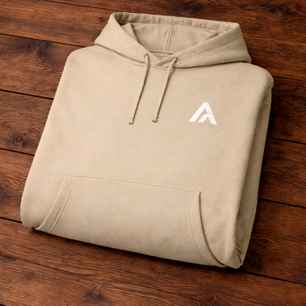 Beige hoodie with a logo on a wooden surface