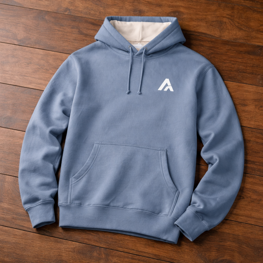 Blue hoodie with a white logo on a wooden surface