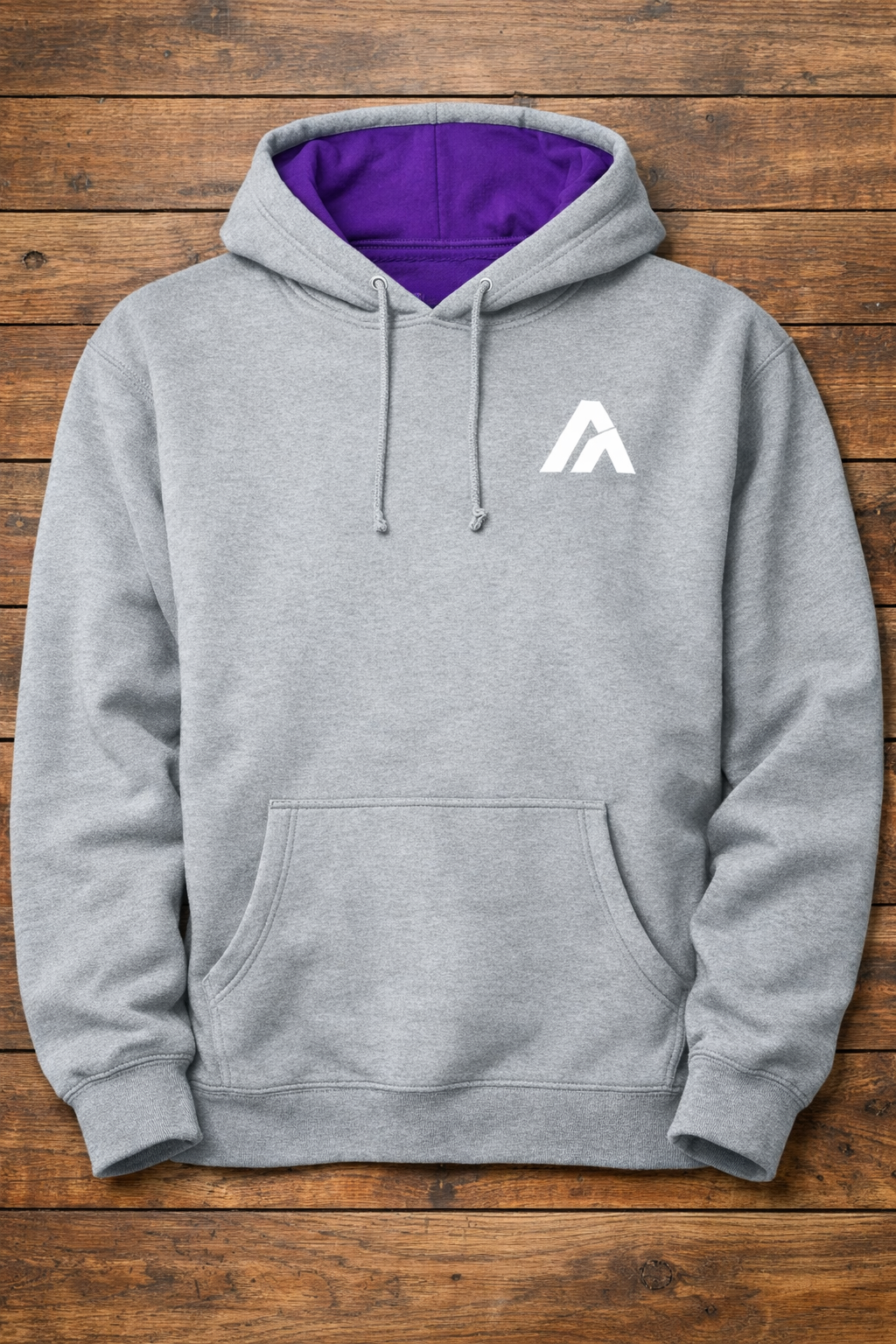 Gray hoodie with a white logo on a wooden surface