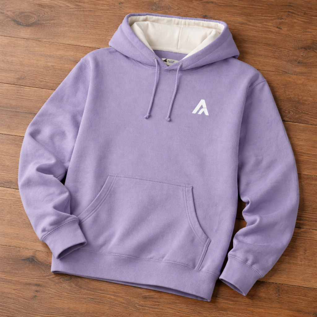 Purple hoodie with a white logo on a wooden surface