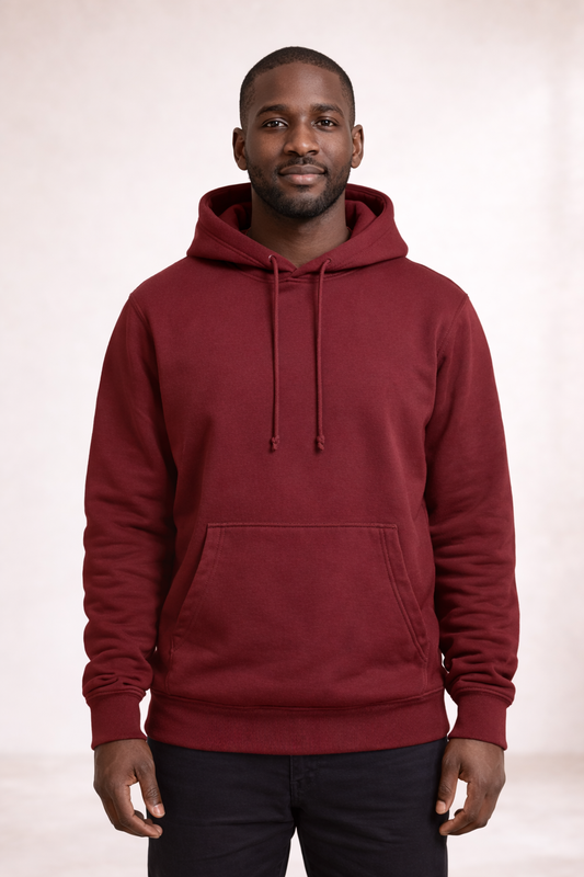 Front view of a man wearing a brick red pullover hoodie with drawstrings and kangaroo pocket.