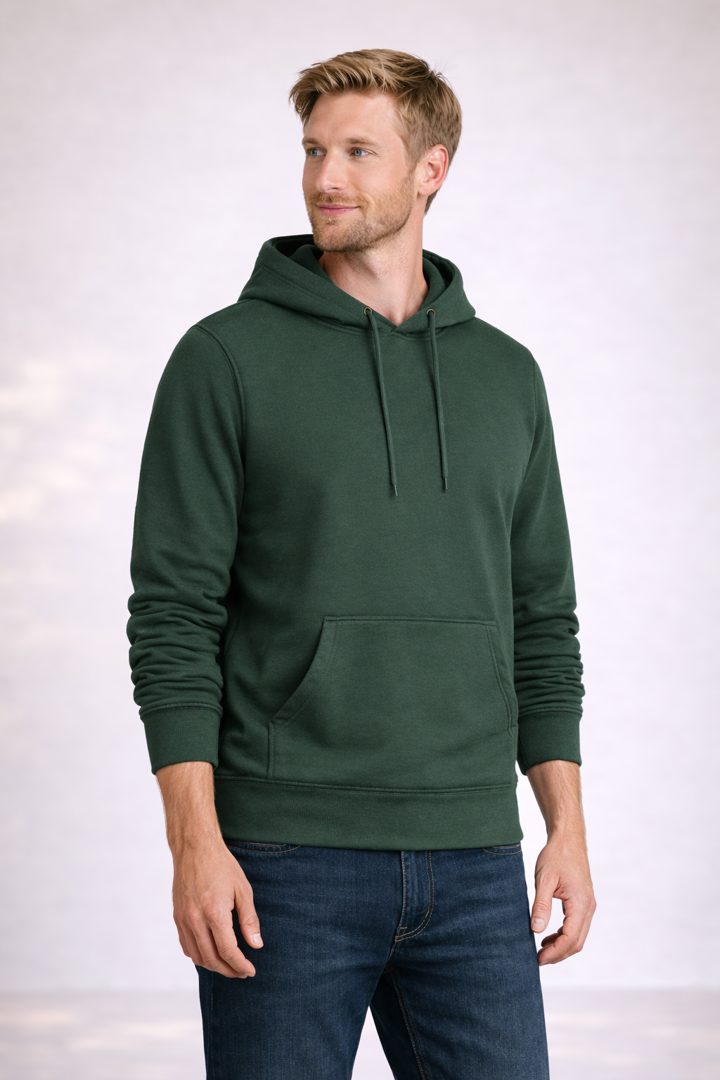 Man wearing a mens forest green pullover hoodie shown in front angled view with drawstring hood and kangaroo pocket.