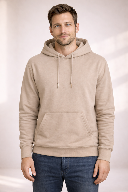 Front view of a man wearing a plain light beige pullover hoodie with drawstrings and kangaroo pocket.