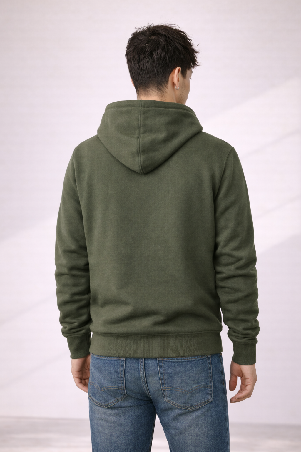 Back view of a man wearing an olive green pullover hoodie with hood and ribbed hem.