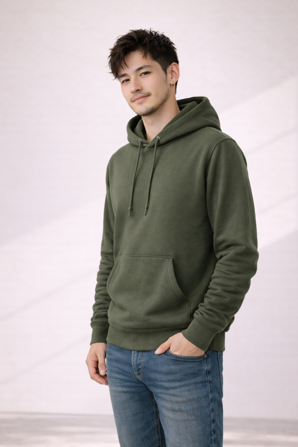 Man wearing an olive green pullover hoodie shown in front angled view with drawstring hood and kangaroo pocket.
