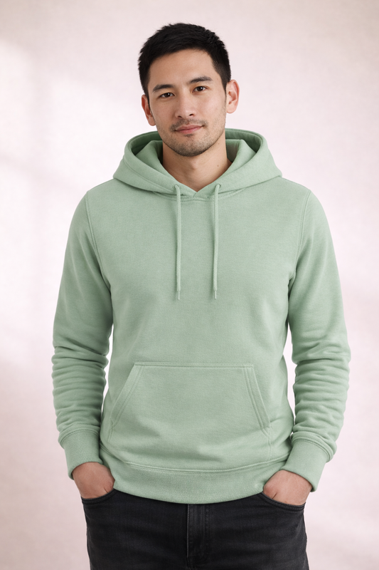 Front view of a man wearing a sage green pullover hoodie with drawstrings and kangaroo pocket.