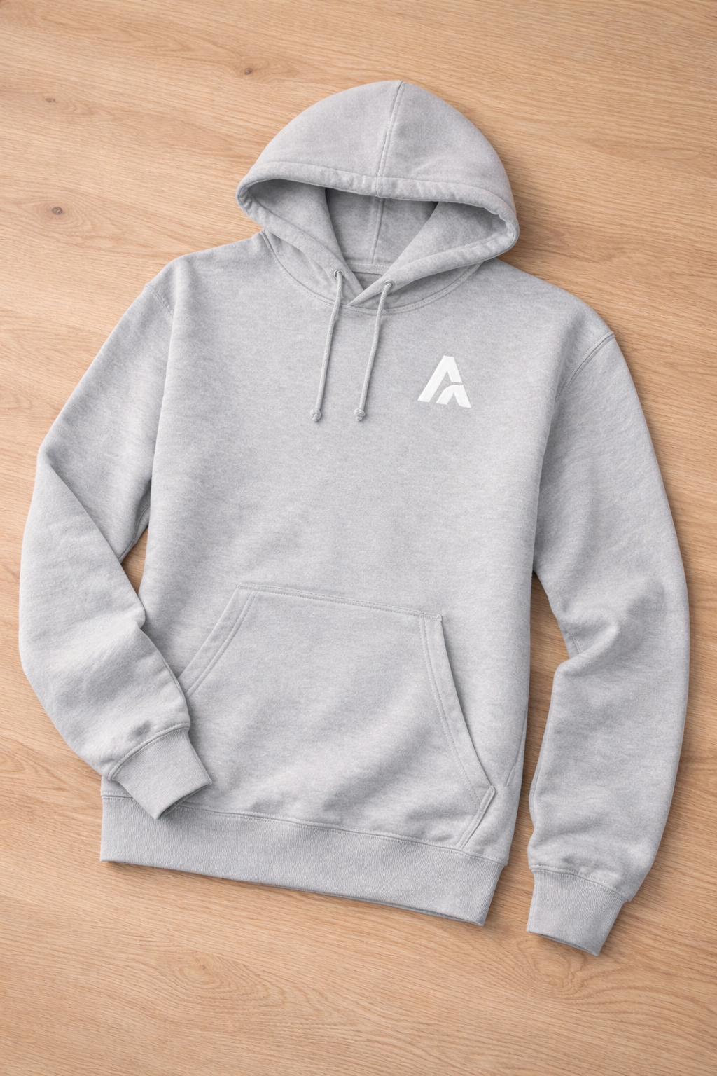 Gray hoodie with a logo on a wooden surface